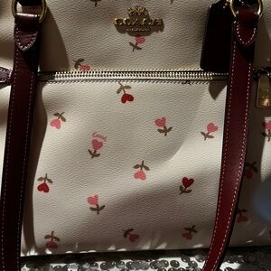 Coach large tote with heart, flowers, leather straps, and the color ox blood